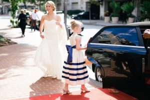 Bride and flower girl about to enter a limousine